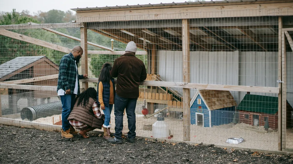 Family visiting an educational farm with animals outdoors