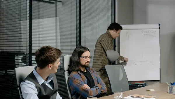 Team of professionals reviewing a web project during an office meeting