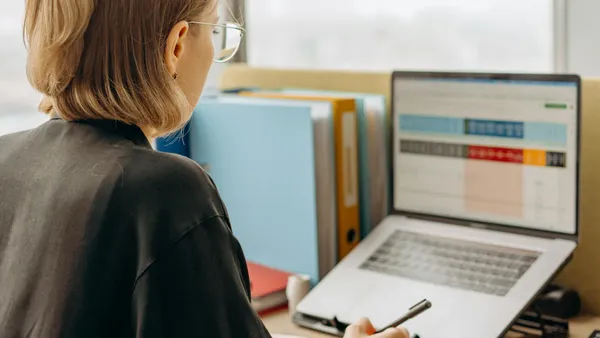 Professional reviewing website performance metrics on a computer screen