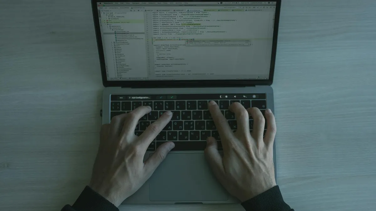 Person working on a laptop with multilingual web content