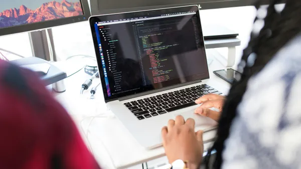 Person comparing website creation options on a laptop screen